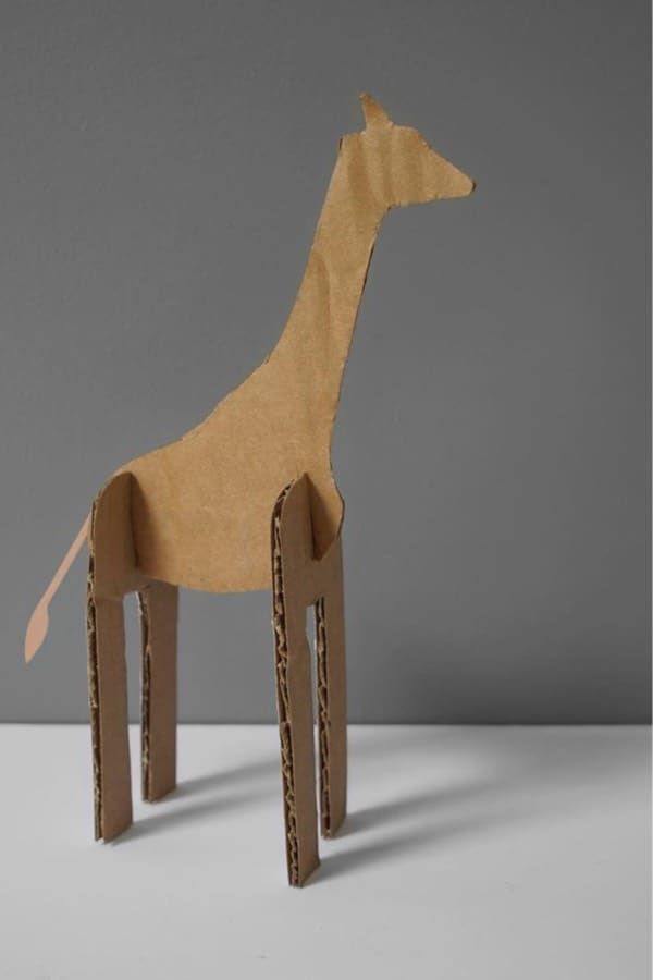 a cardboard giraffe standing upright on a table