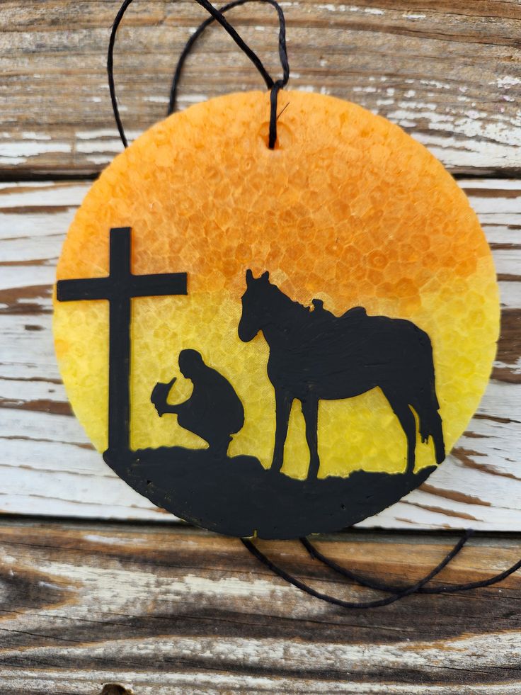 a nativity ornament with a silhouette of a horse and a baby jesus