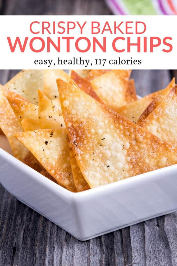 crispy baked wonton chips in a white bowl on top of a wooden table