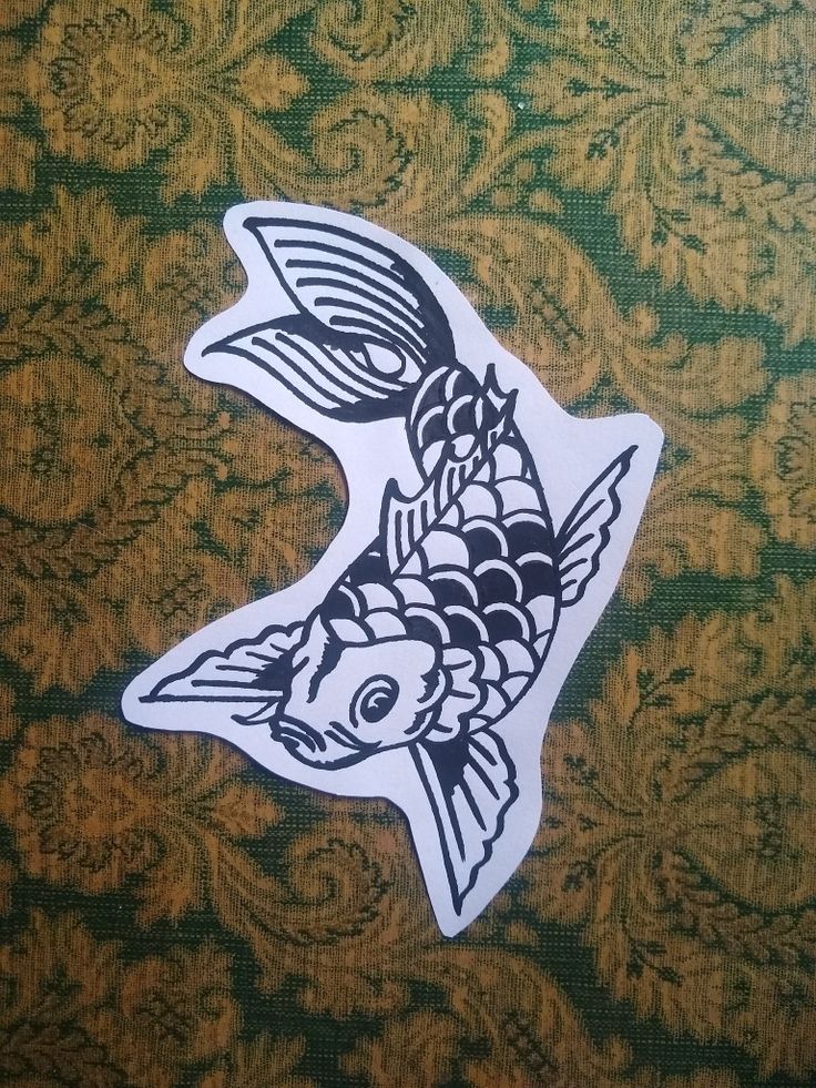 a fish sticker is on the side of a green and gold patterned wallpaper