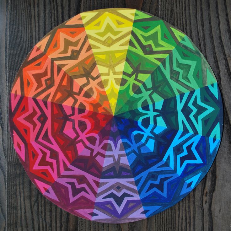 a multicolored paper plate sitting on top of a wooden table