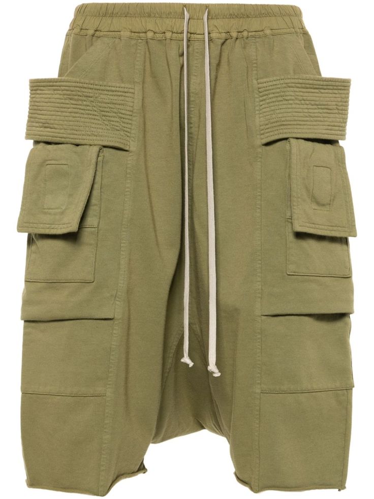 sage green organic cotton elasticated drawstring waistband layered details two side pouch pockets two side cargo pockets drop crotch two rear flap pockets below-knee length This item is made from at least 50% organic materials. Learn more about what makes a product Conscious on our Conscious Criteria page City Shorts, Rick Owens Drkshdw, Organic Materials, Balenciaga Triple S, Custom Watch, Summer Beach Wear, Short Suit, Sweaters Knitwear, Drawstring Waistband