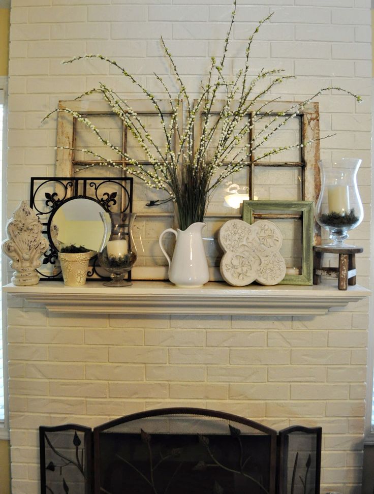 a fireplace is decorated with vases and other items on top of the mantel