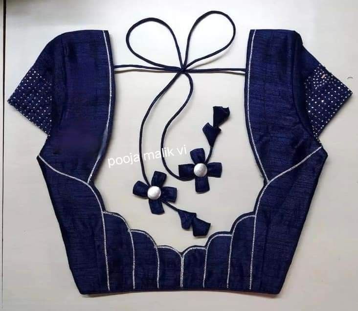 the back of a woman's blouse made out of blue fabric and white beads