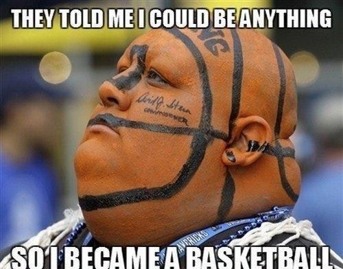 a man with his face painted like a basketball