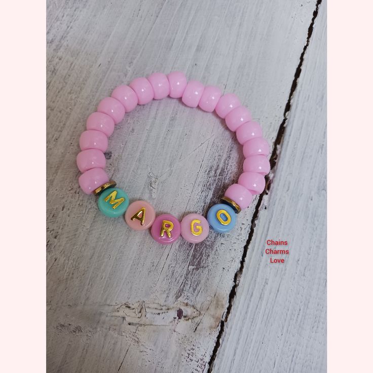 These fun handmade personalized bracelets for little girls are oh so adorable. Made of pink pony beads and designed to fit age toddler to 12 years old. Adjustable Pink Charm Bracelet With Letter Beads, Playful Pink Charm Bracelet For Birthday, Fun Adjustable Pink Charm Bracelet, Playful Pink Charm Bracelet For Gift, Adjustable Pink Charm Bracelet Fun Style, Playful Pink Charm Bracelet As Gift, Pink Adjustable Bracelet For Birthday, Adjustable Pink Bracelet For Birthday, Pink Charm Bracelet With Round Beads For Friendship