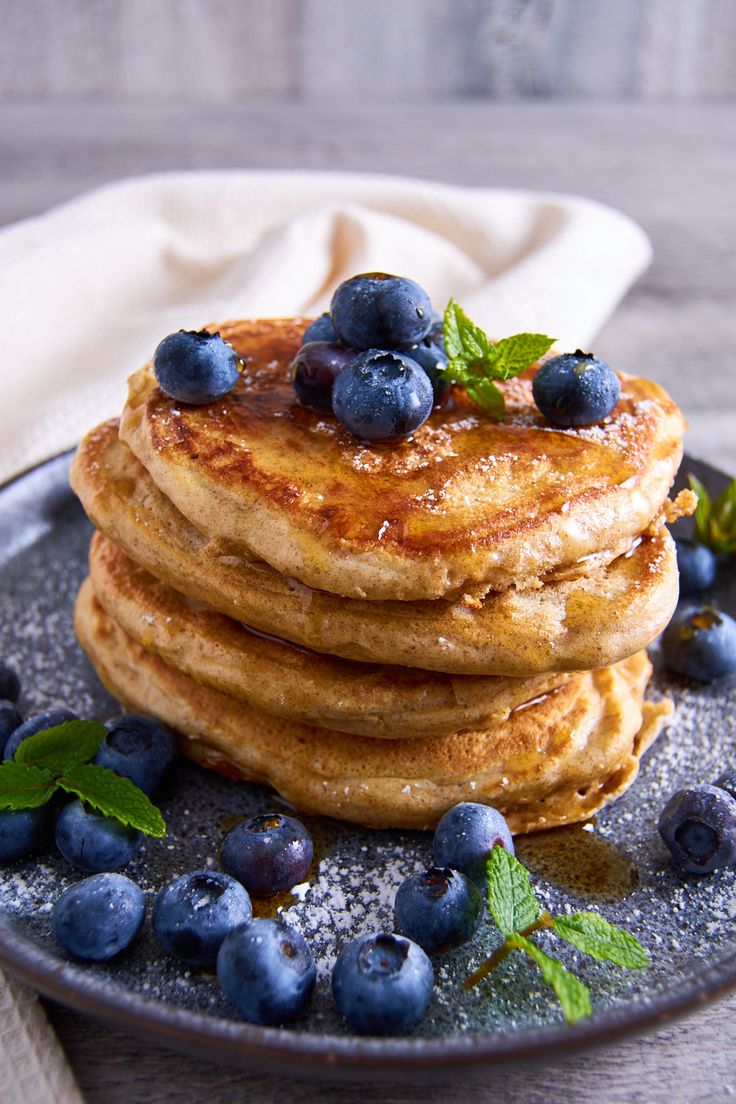 A stack of fluffy sourdough protein pancakes topped with blueberries, icing sugar and maple syrup, decorated with a few mint leaves. Vanilla Protein Shake, Sourdough Pancakes Recipe, Protein Powder Pancakes, Sourdough Muffins, Recipe Using Sourdough Starter, High Protein Pancakes, Greek Yogurt Pancakes, Yogurt Pancakes, Sourdough Pancakes