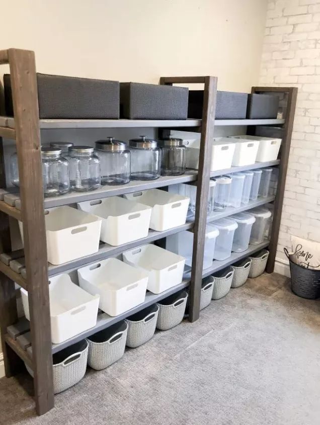 the shelves are filled with plastic containers and bins for storing items or other things