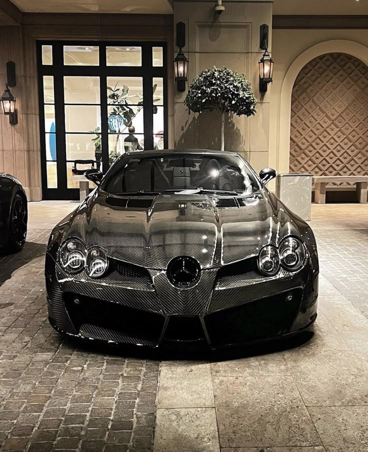 a black sports car parked in front of a building