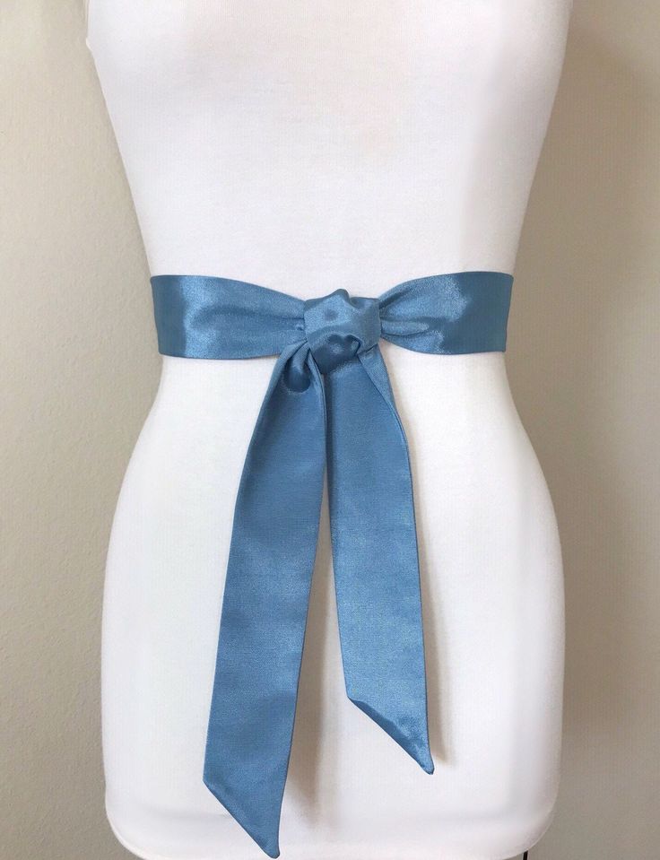 "Narrow Smoke Blue Satin Sash Ribbed Smoke Blue Sash Belt Blue Gray Wedding Dress Sash Bridal Sash, Gray Blue Satin Sash Belt Satin Swank Make this Satin Swank® reversible waist sash the perfect finishing touch for your bridesmaid, wedding, or special occasion dress, or just the right piece to add instant polish to your dress or top. Depending on your waist size and the length you choose (60, 75, and 90 inch lengths available), you can wrap the sash around your waist once or twice. You decide wh Fitted Satin Bow Sash For Bridesmaids, Elegant Blue Party Sashes, Formal Fitted Sash With Tie Back, Elegant Blue Sashes For Wedding, Formal Fitted Sash With Tie Waist, Elegant Blue Bridal Belt For Wedding, Blue Gray Wedding, Gray Wedding Dress, Cobalt Wedding