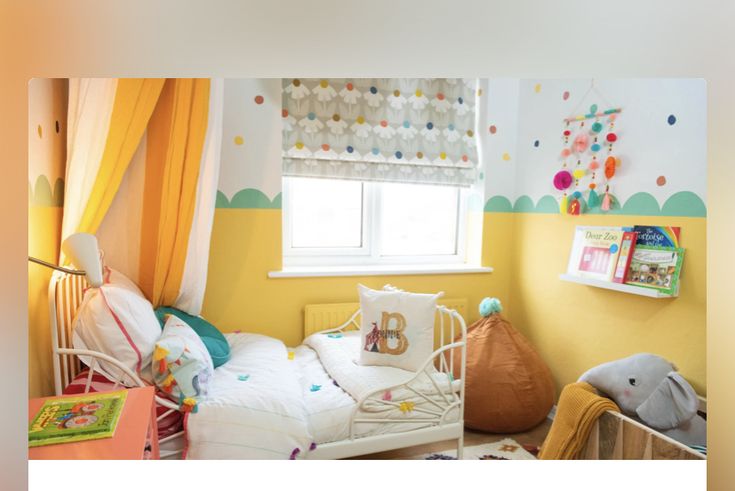 a child's bedroom with yellow walls and curtains