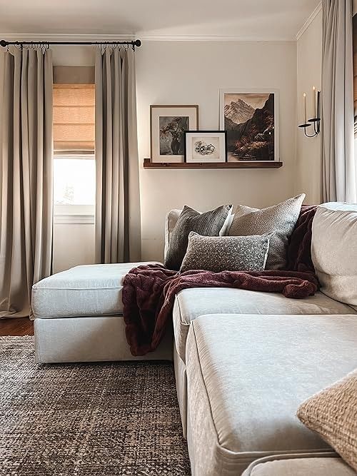 a living room filled with furniture and curtains