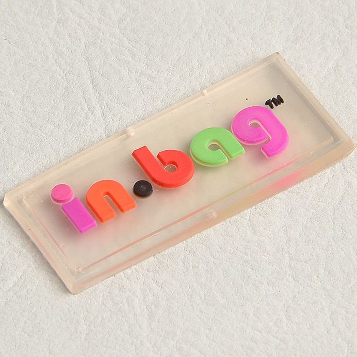 a plastic name plate with the word pop spelled out in neon colored letters on it