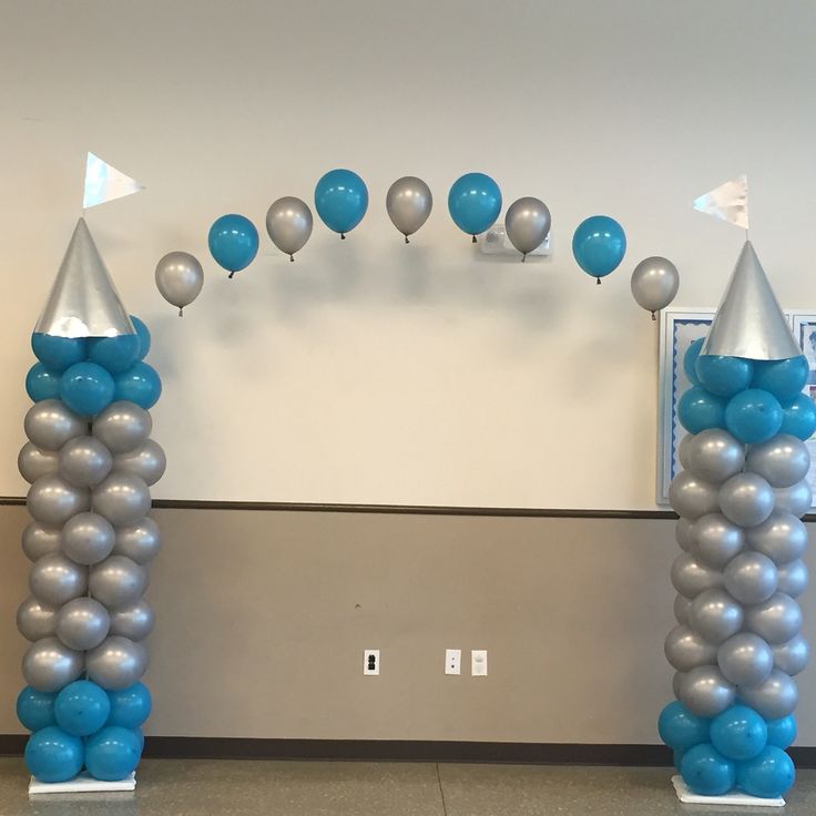 an arch made out of silver and blue balloons