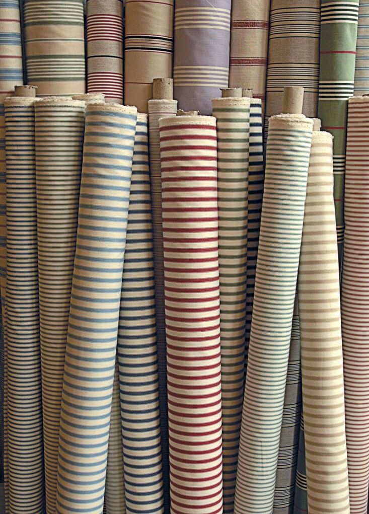 many different colored striped rugs on display