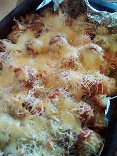 a casserole dish covered in cheese and meat