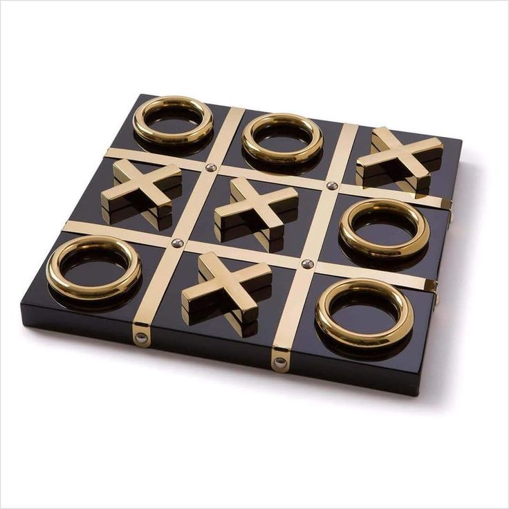 a black and gold tic - tac - toe board with rings on it