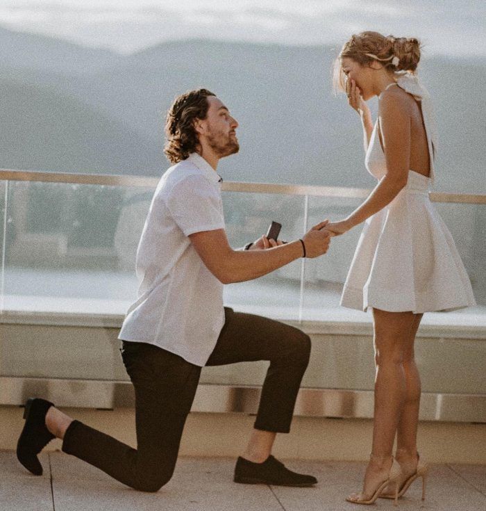 a man kneeling down next to a woman