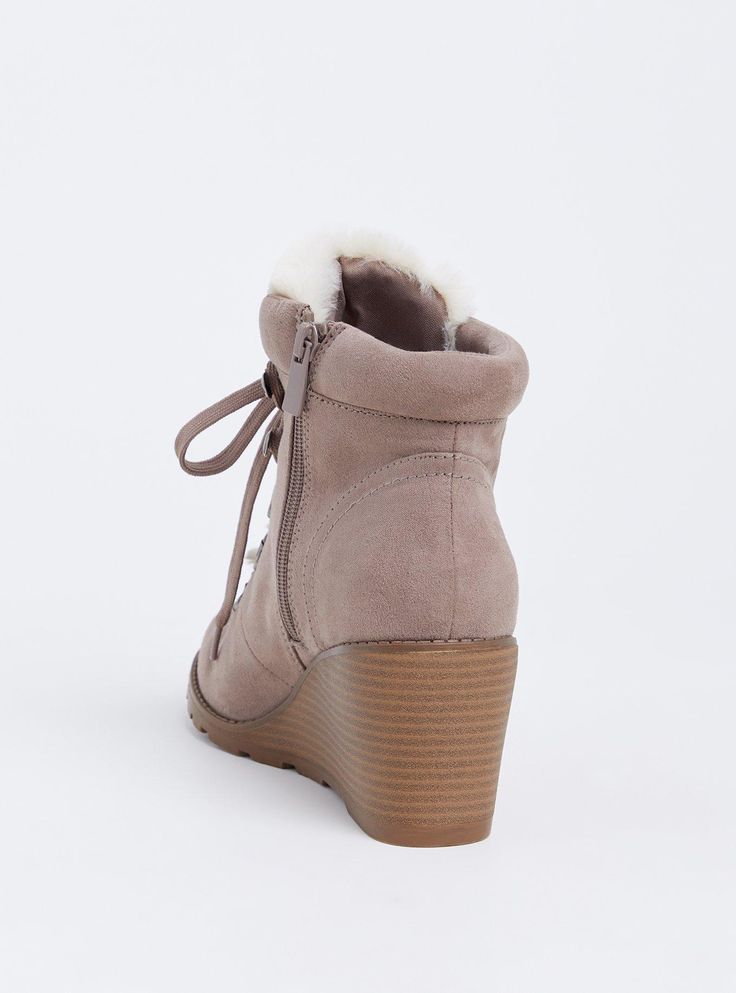 Cozy and cute, these faux suede booties are designed with faux sherpa accents and with a small wedge heel to take you from day to night in style. Our unique fit gives you extra wide width and extra room around your whole foot. EXTRA WIDE WIDTH (WW). Almond toe. Side zip and lace-up closures. Contrast padded faux fur trim. 2. 75” wedge heel. Extra cushioned footbed; textured sole. Man-made materials. Imported extra wide width shoes. The best plus size women's sherpa wedge bootie (ww) flatform & heels in taupe made of suede. Rock your look from Torrid to Festivals like Coachella and Lollapalooza, a concert, a show, or just for fun! Torrid is your destination for cozy fall and winter clothes to keep you warm and comfortable. Synthetic Winter Wedge Heel Boots, Winter Synthetic Wedge Heel Boots, Synthetic Wedge Heel Boots For Winter, Casual Wedge Heel Boots For Winter, Casual Wedge Boots For Winter, Winter Suede Boots With Wedge Heel, Suede Wedge Heel Boots For Winter, Suede Wedge Heel Winter Boots, Casual Winter Synthetic Wedge Boots