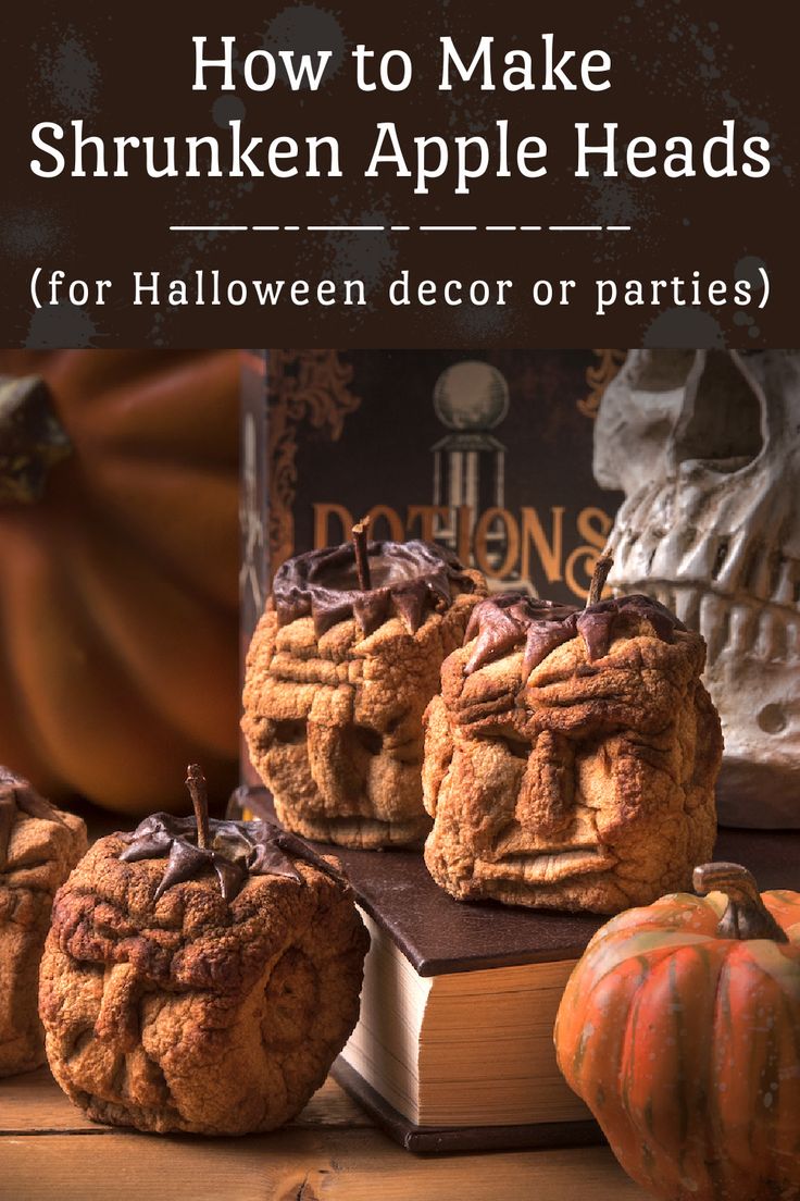 three pumpkin shaped cookies sitting on top of a table next to a stack of books