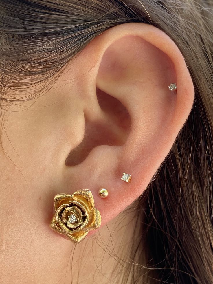 "Cute and dainty 14k solid gold flower design with a natural diamond set in the center. These earrings are set in 14k gold push back closure and a brushed, texture gold finish. Hypoallergenic and double rhodium plated for an extra shiny finish. <> ✔ 14k Solid Gold ✔ Length: 1.50 cm ✔ Width: 1.50 cm ✔ Diamonds: 2 natural diamonds, round cut, 0.05 carats ✔ Hypoallergenic ✔ Double Rhodium Plated Finish ✔ Weight: 6.2 grams Diamond stud earrings: https://www.etsy.com/listing/805062727/tiny-natu Gold Flower Diamond Earrings With Prong Setting, Gold Flower Jewelry With Single Cut Diamonds, Gold Flower-shaped Jewelry With Single Cut Diamonds, Fine Jewelry 14k Gold Diamond Earrings With Flower Shape, 14k Gold Flower Shaped Diamond Earrings, 14k Gold Diamond Earrings With Flower Shape, 14k Gold Diamond Earrings In Flower Shape, Gold Diamond Flower Earrings For Wedding, Yellow Gold Flower Earrings With Diamond Accents