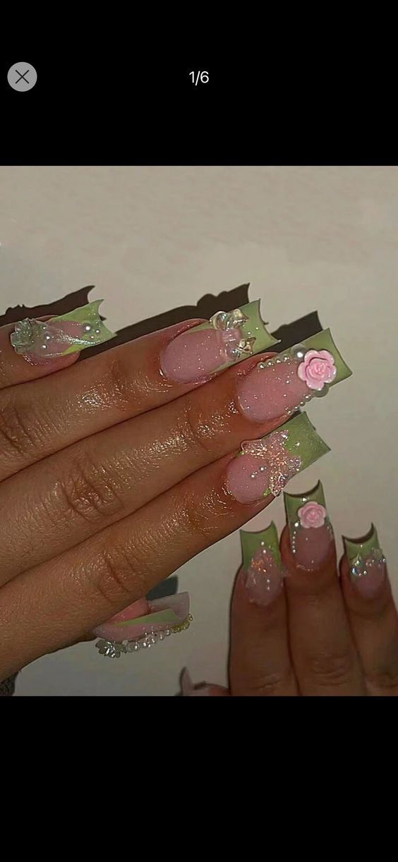 a woman's nails with pink and green designs on them