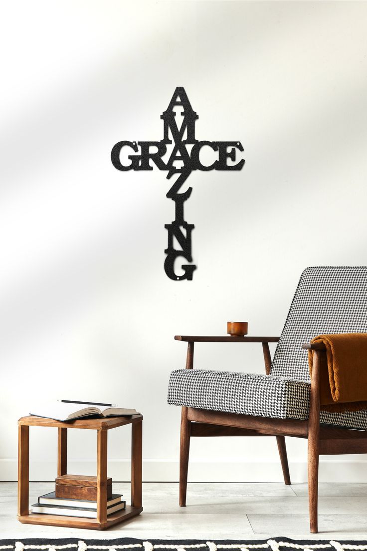 a living room with a cross on the wall and a chair in front of it