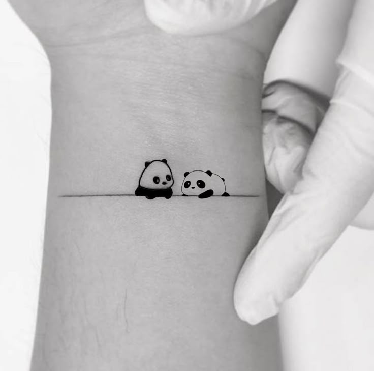 two panda bears on the wrist tattoo