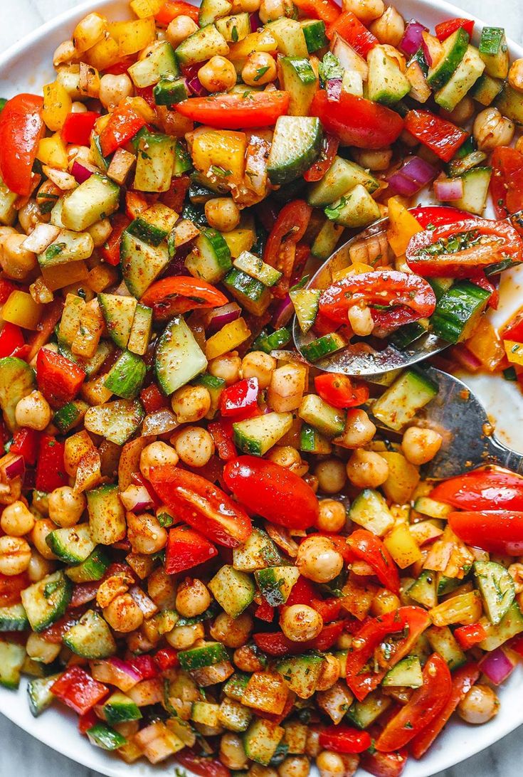 a white bowl filled with chickpeas and veggies