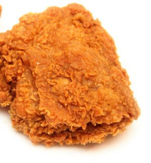 two pieces of fried chicken on a white background