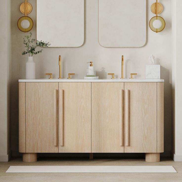 a bathroom vanity with two mirrors above it and gold accents on the wall behind it