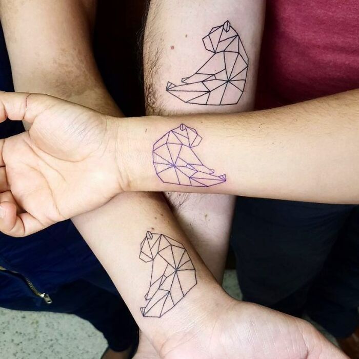 two people with matching tattoos on their arms