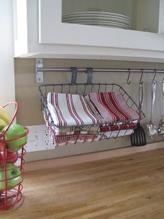 a rack with towels and utensils hanging from it