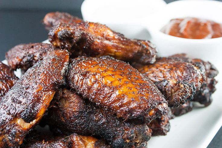 chicken wings on a plate with dipping sauce