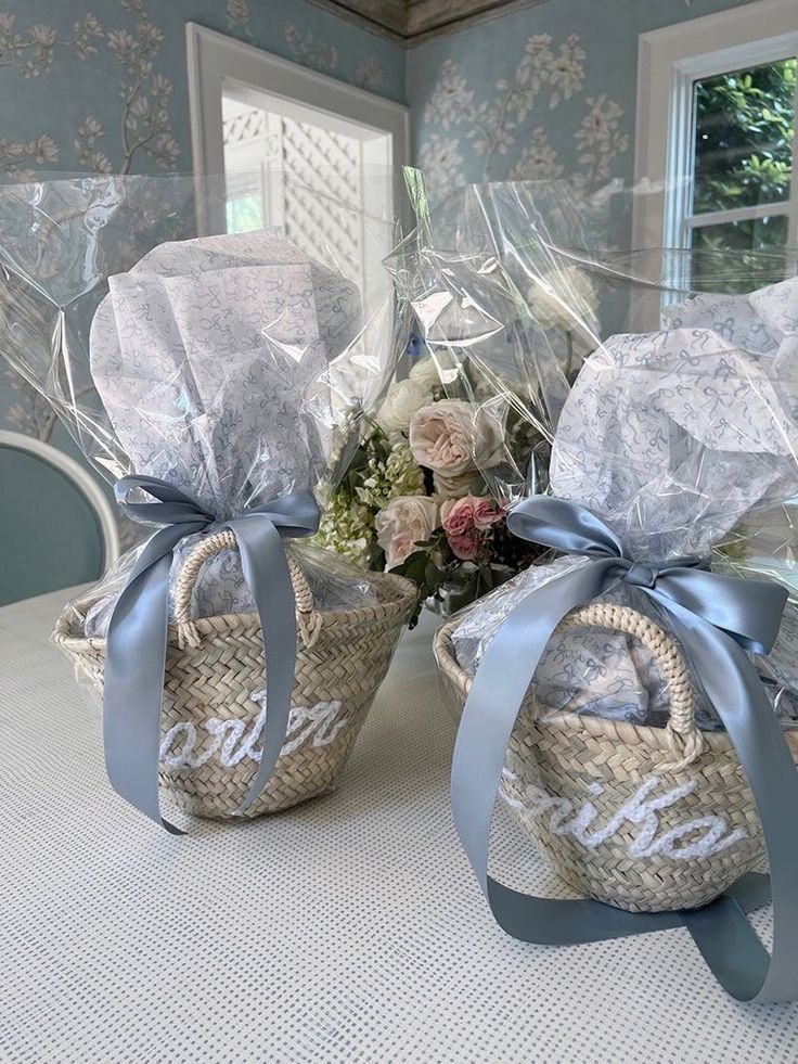 two baskets filled with flowers sitting on top of a table