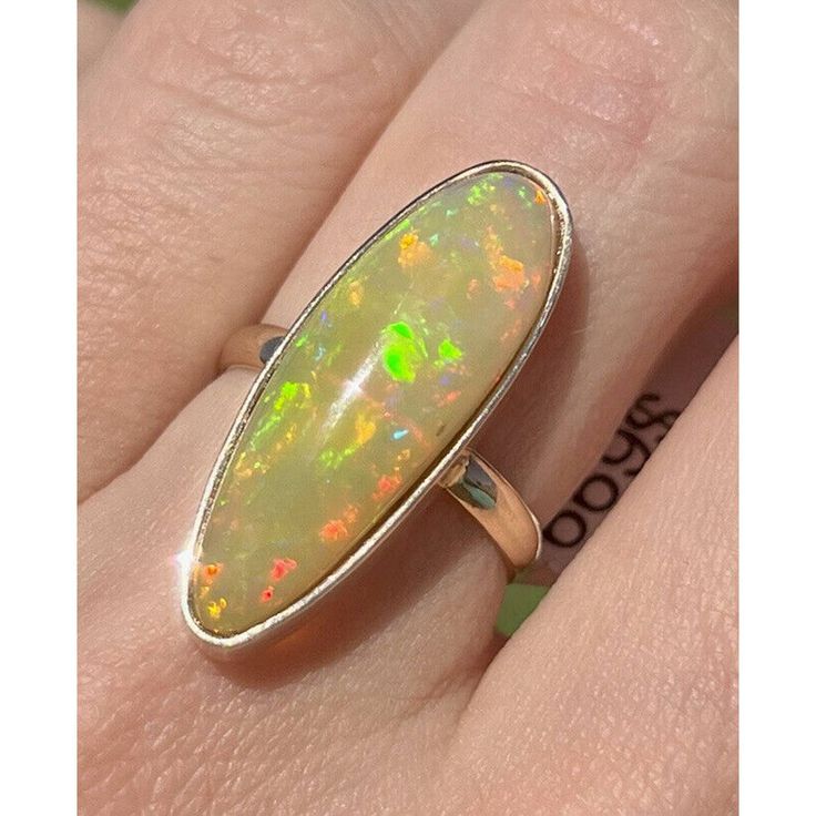 14k Solid Yellow Gold Natural Ethyopian Opal Bezel Set Long Ring. 3.73 Grams Size 6.5 26.7mm X 9.7mm Top Opal Natural Ehiopian Opal This Is Part Of Our Handmade Collection The Gold Carat Might Very Between 13k And 15k Gold Due To Being Handmade Yellow Gold Polished Opal Ring, Gold Sterling Silver Opal Ring With Polished Finish, Sterling Silver Opal Ring With Bezel Setting, Yellow Gold Oval Opal Ring In Sterling Silver, Oval Yellow Gold Opal Ring In Sterling Silver, Formal 14k Gold Opal Ring With Bezel Setting, Silver Oval Opal Ring In 14k Gold, Silver Opal Ring In 14k Gold With Oval Shape, Silver Opal Ring In 14k Gold For Formal Occasions