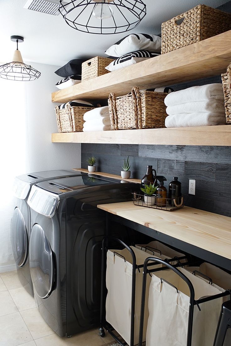 a washer and dryer in a small room with shelves above the washer