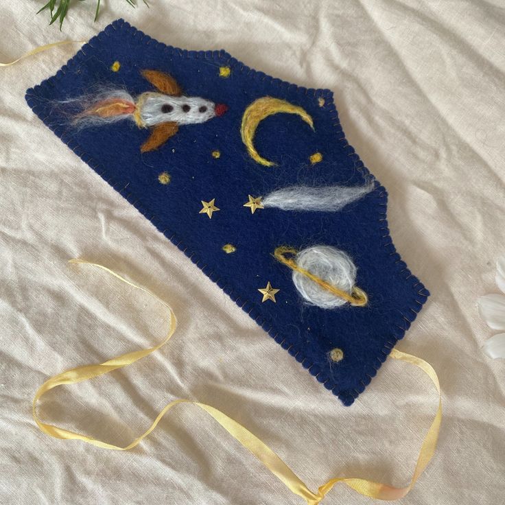 a blue piece of cloth with space and stars on it