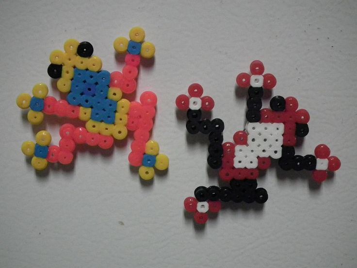 two pieces of bead art sitting next to each other