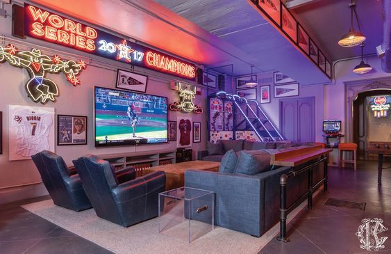 a living room filled with furniture and a flat screen tv mounted to the wall next to a bar