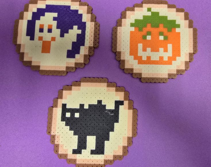 three coasters made to look like pixelons with pumpkins and cats on them