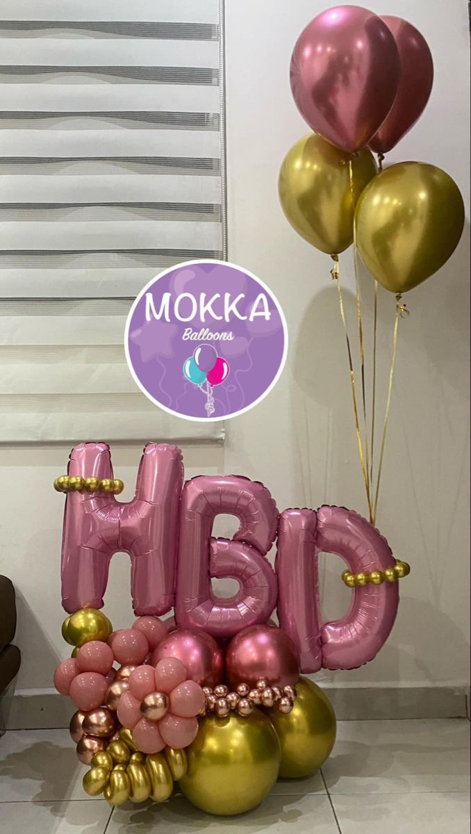 pink and gold balloons with the letters h b d