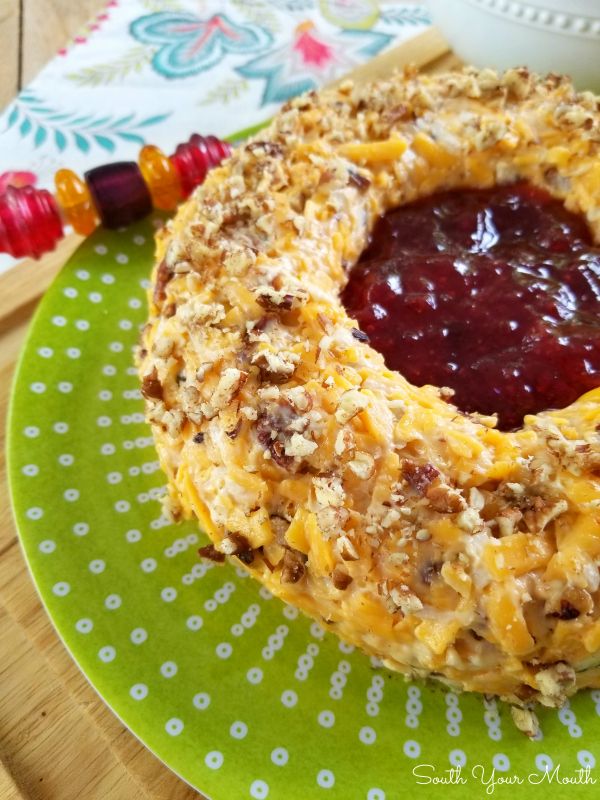 a bundt cake with jelly and nuts on a green plate