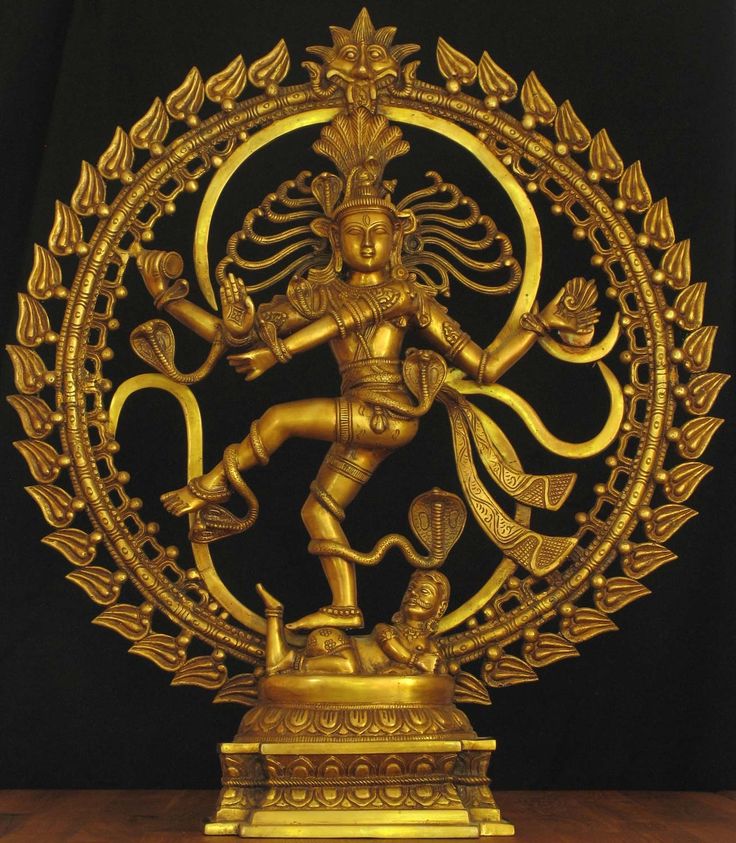 a golden statue is displayed in front of a black background