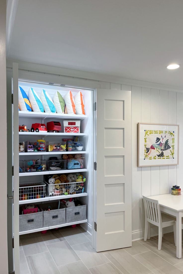 a room with white walls and shelves filled with toys