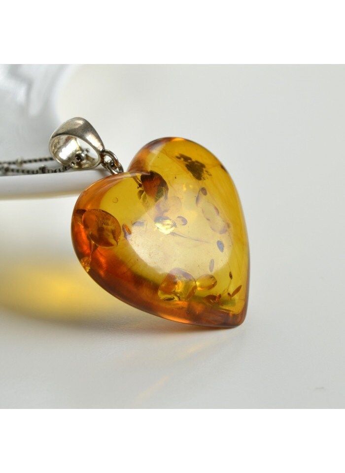 Natural Baltic Amber Pendant in 14K gold-plated 925 Silver. Choose one of our exquisite jewelry pieces to give as a unique gift to someone special. Material: Natural Baltic Amber and 14K Gold-plated 925 Silver Pendant length with clasp: 50 mm Weight: 12 g Color: Cognac/Yellow The neck-chain is not part of the set. Royal Cherry Amber Donut Pendant. The leather cord with silver clasp is included. Material: Genuine Baltic Amber Size: 36 x 11 mm/ 1.4 x 0.43 in. Weight: 10.10 g/ 0.022 lb Color: Cherr Donut Pendant, Amber Pendant, Amber Ring, Neck Chain, Silver 925 Necklace, Amber Jewelry, Silver Material, Baltic Amber, Exquisite Jewelry