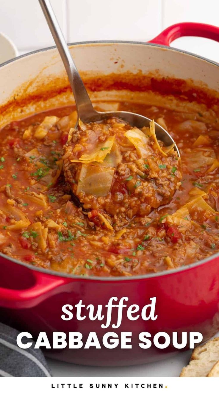 stuffed cabbage soup in a red pot with a ladle scooping up some food