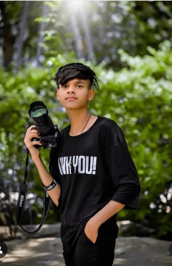 a young man holding a camera in his hand