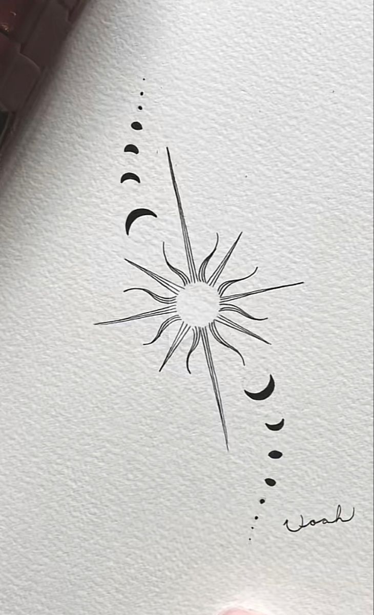 a drawing of a sun and stars with ink on paper next to a marker pen