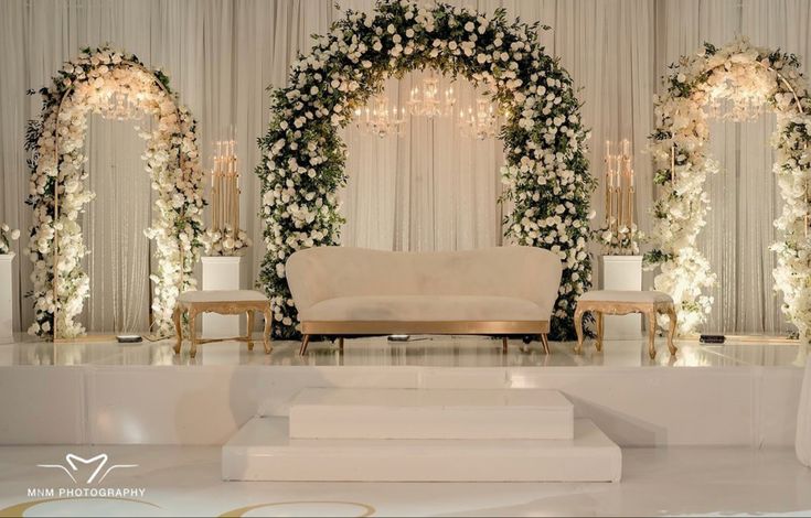 an elegant wedding setup with white flowers and greenery